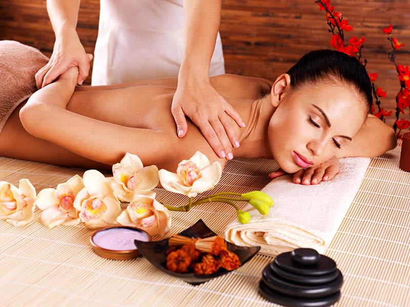 A beautiful young woman receiving a relaxing massage in a beautiful spa