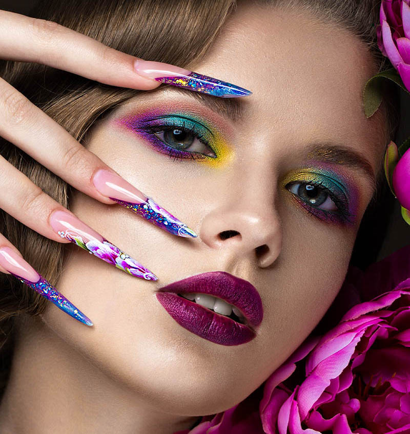 A beautiful woman with brightly colored makeup and exciting nails